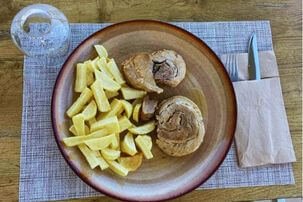 Homemade moussaka served with Greek salad and local wine