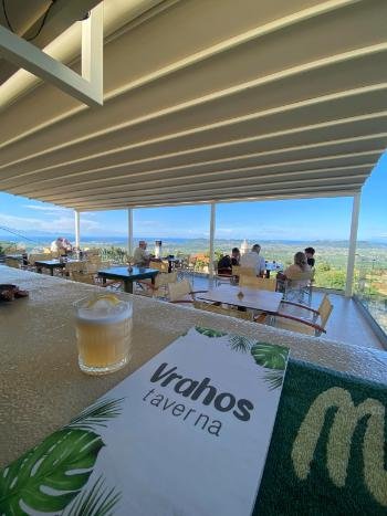 Breathtaking sunset view from the cliffside terrace of Vrahos Taverna