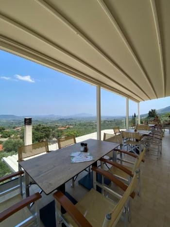 Breathtaking sunset view from the cliffside terrace of Vrahos Taverna