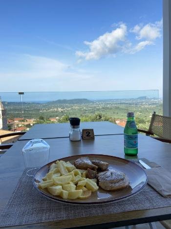 Breathtaking sunset view from the cliffside terrace of Vrahos Taverna